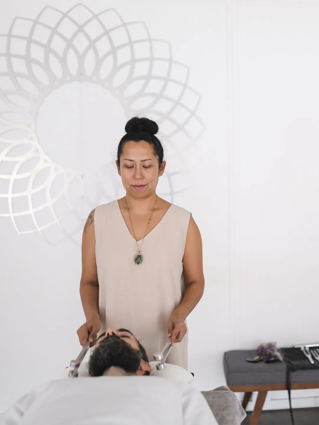 Vanessa Fernandez working with calibrated tuning forks on a client during a biofield tuning session