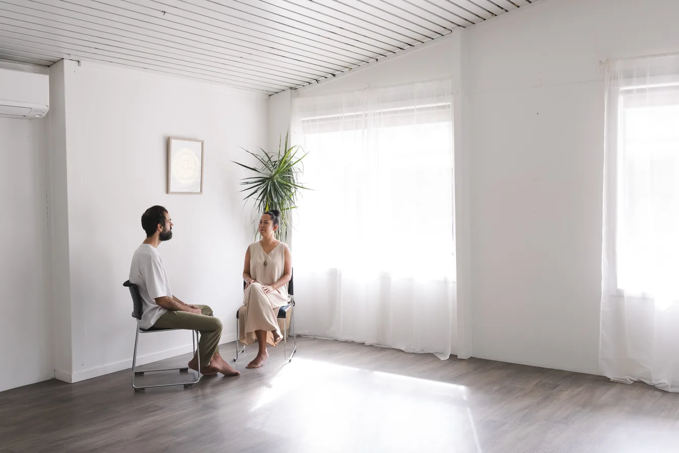 Vanessa Fernandez sitting with a client in conversation before a biofield tuning session at her Mona Vale studio