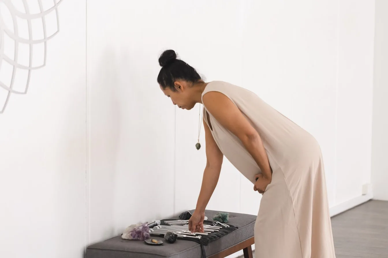 Vanessa Fernandez laying out her tuning forks and crystals before a session