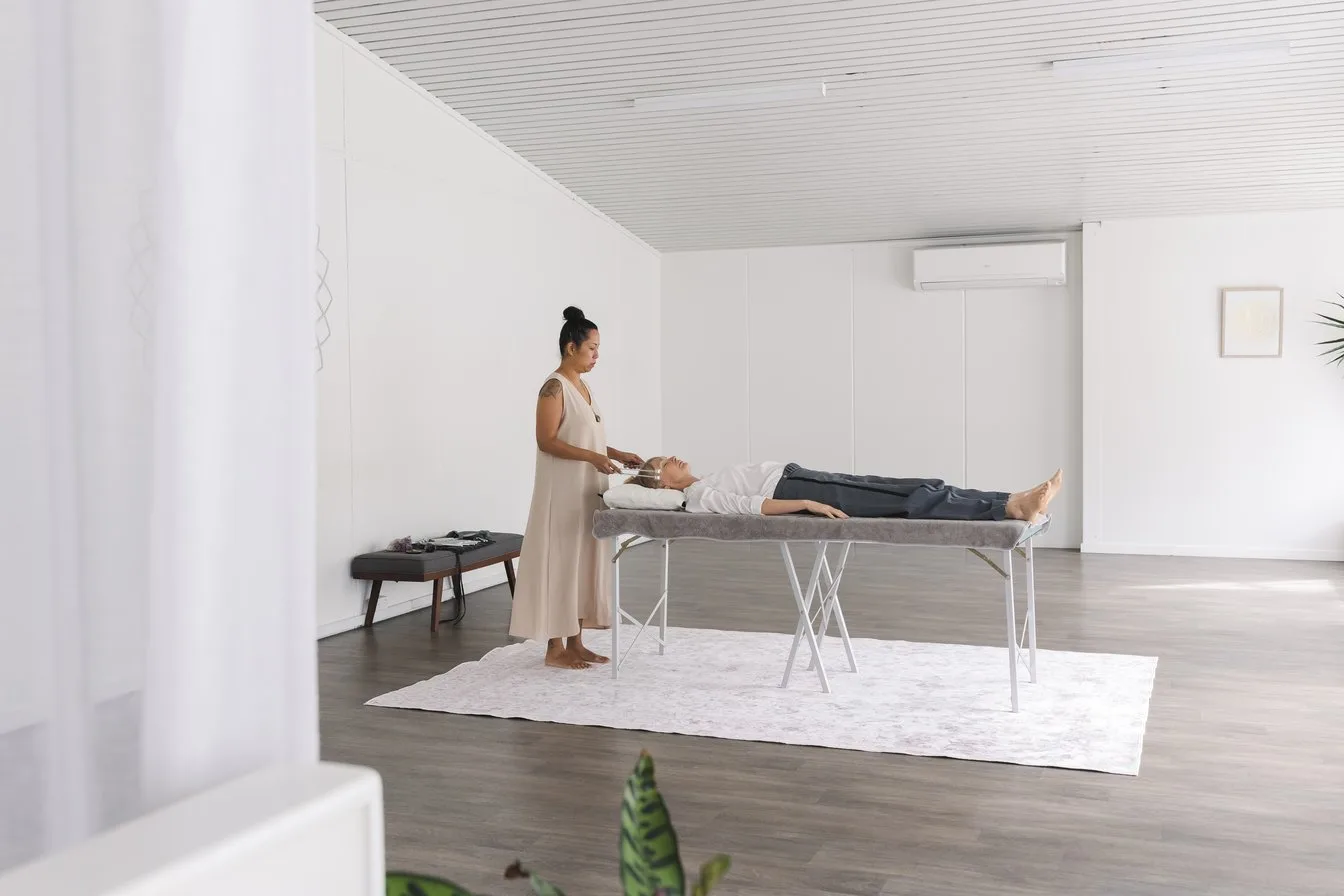 Vanessa Fernandez working with a tuning fork in the field above a client at her Mona Vale studio