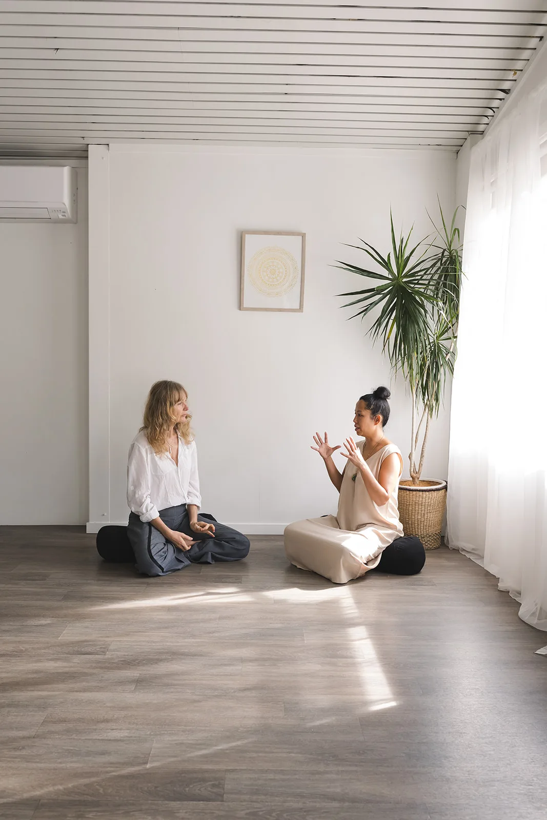 Vanessa Fernandez in conversation with a client before a biofield tuning session at her Mona Vale studio